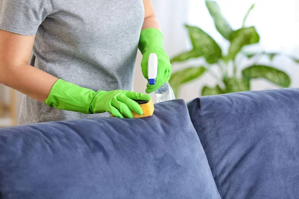 depositphotos_401078732-stock-photo-woman-removing-dirt-sofa-home